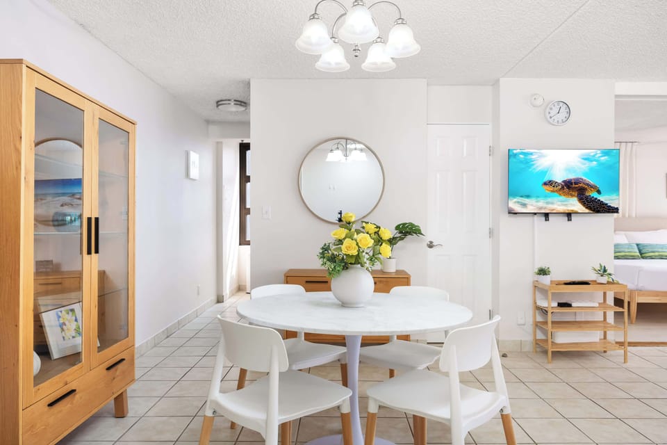 The dining table seats four—perfect for shared meals and lively conversations.