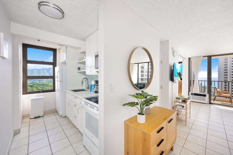 The kitchen area is built with an ample space to move around. It is also equipped with refrigerator, stove, microwave, and other essential kitchen tools for added convenience during your stay.