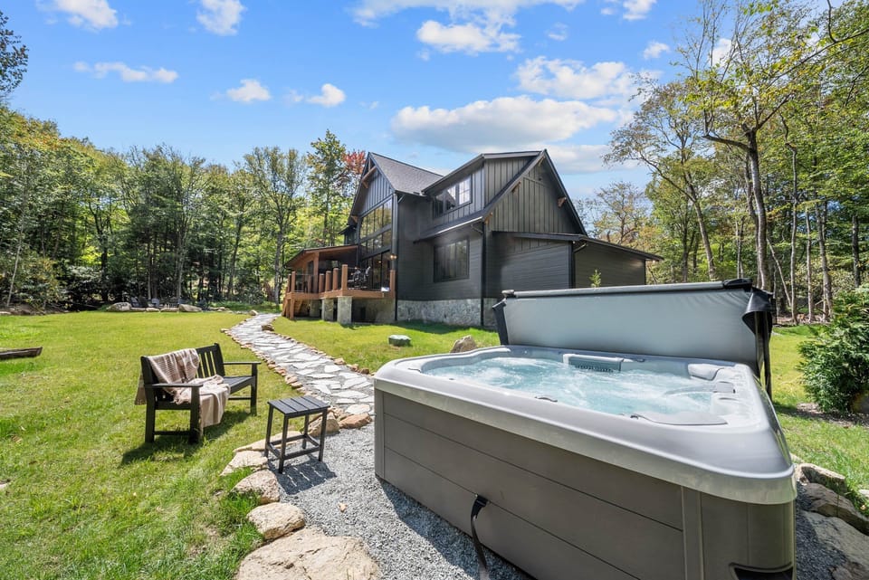 Soak under the open sky surrounded by Blue Ridge woods. The hot tub and sprawling yard make unwinding effortless at Creek Crossing At Eagles Nest.