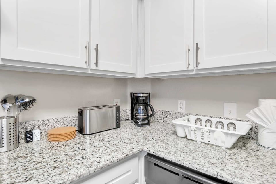 Polished kitchen counters w/ plenty of prep space & modern style.