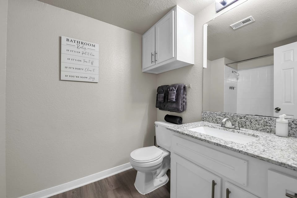 Compact bathroom w/ toilet and a clean, practical layout.
