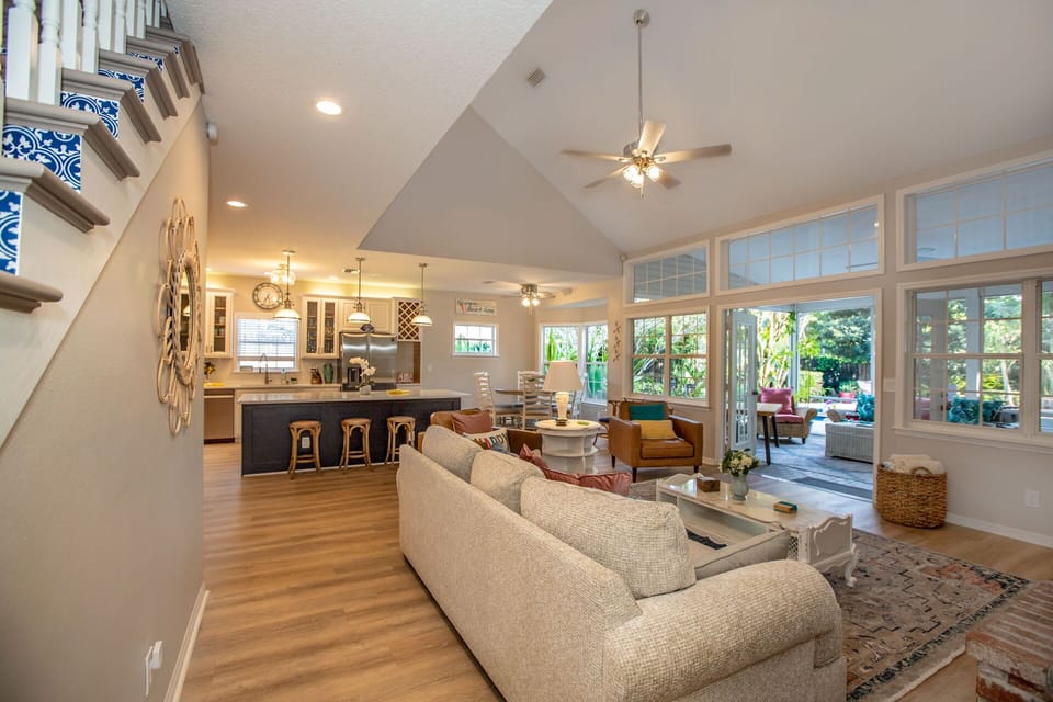 The patio door from the living room opens up to a large covered lanai with additional seating and ping pong table