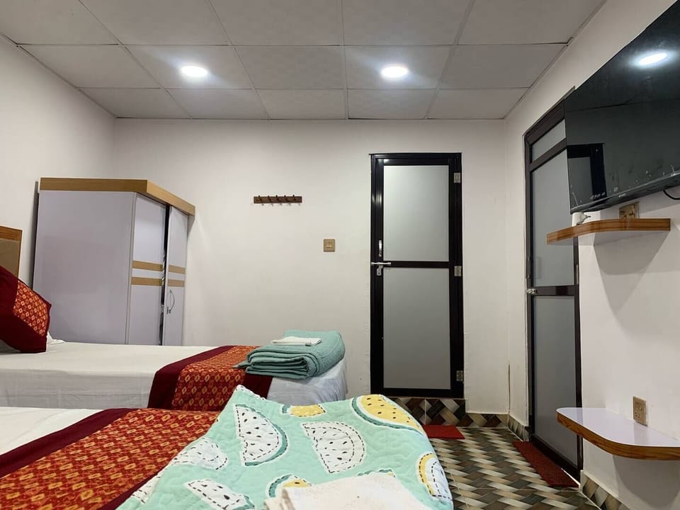 Triple Room, Garden View | Desk, laptop workspace, blackout drapes, free WiFi