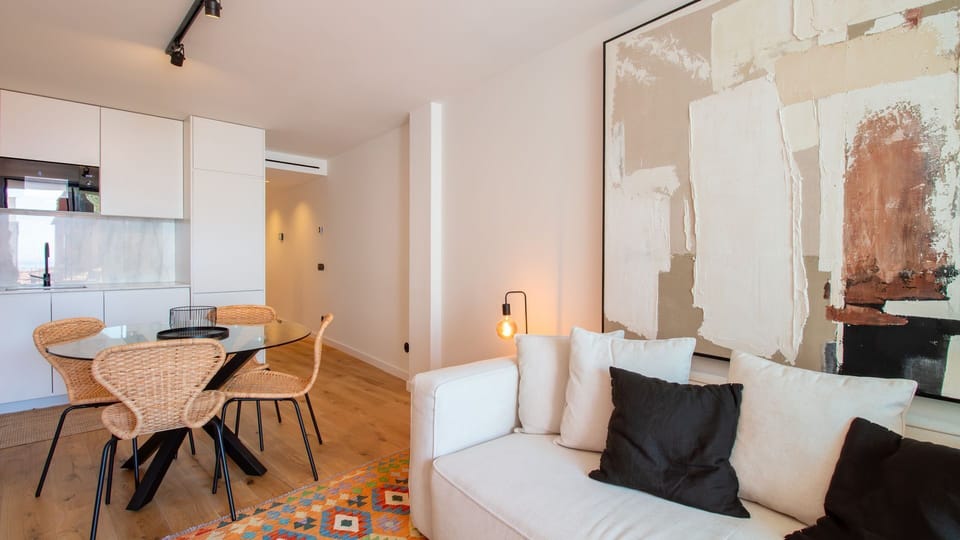 Modern design meets comfort in this chic space, connecting kitchenette and lounge seamlessly. #DesignApartment #Foz