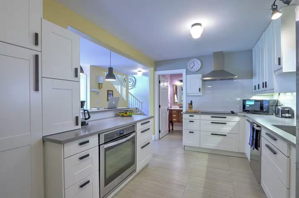 Modern kitchen with sleek counters and new stainless appliances
