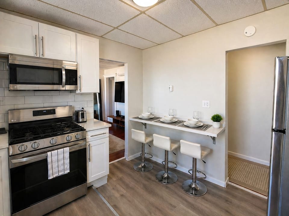 Stylish kitchen with gas range and sleek breakfast bar seating for 3