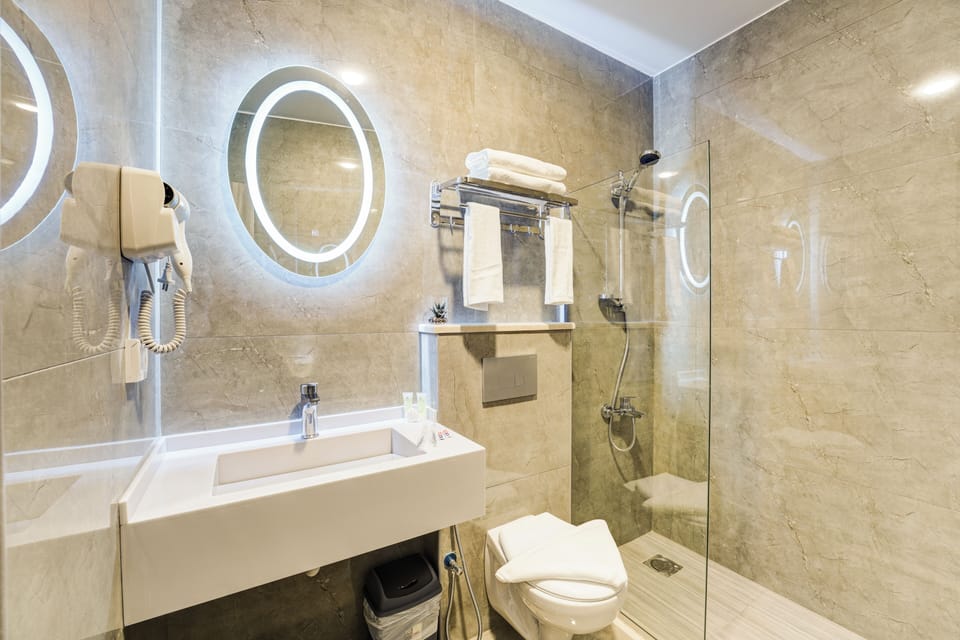 Shower, hair dryer, slippers, towels