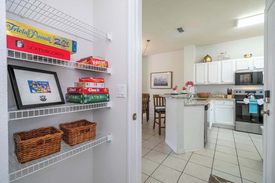 Family-friendly fun: shelves of classic board games by the kitchen and dining bar-perfect for cozy game nights together!