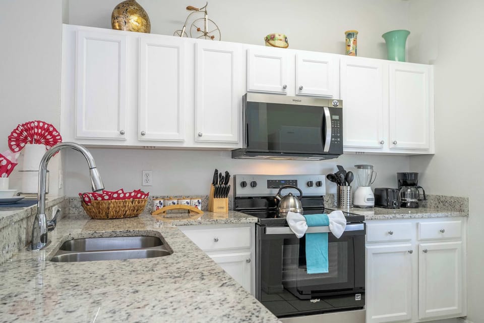 Cook with ease in the fully stocked kitchen-granite counters, stainless range and microwave, plus coffee maker, toaster, and blender.