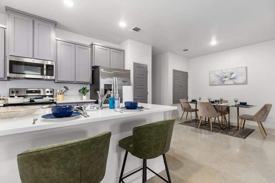 Kitchen Delight: Modern cabinetry and sleek appliances make culinary adventures a breeze! Seating for 2 at the breakfast bar and 4 at the table.