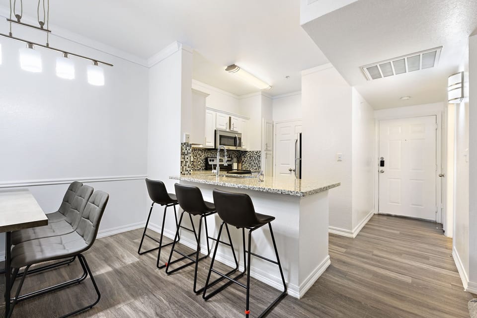 Modern dining for 6 with a sleek kitchen island bar for casual meals.