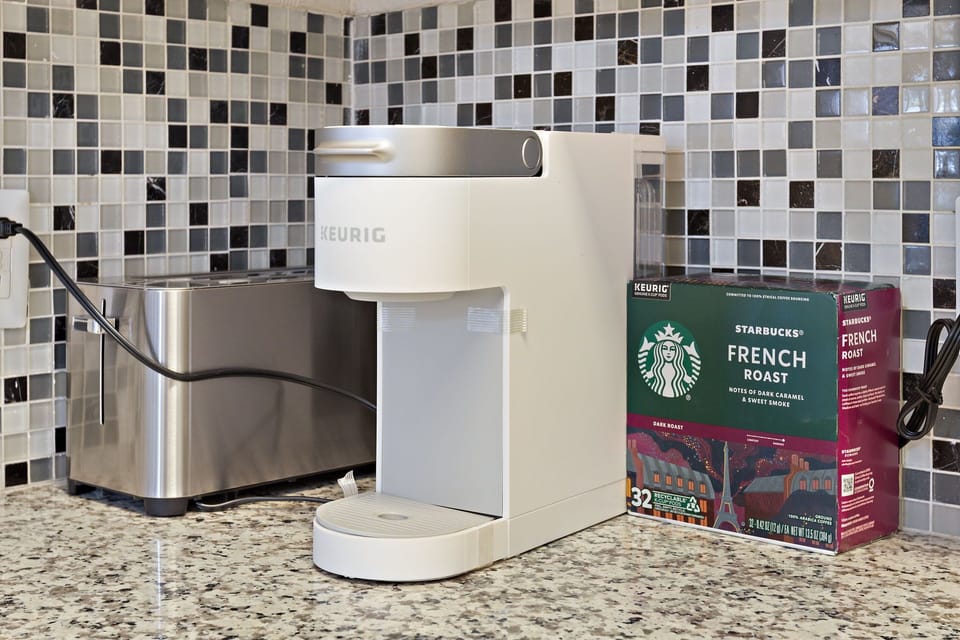 Modern, fully equipped kitchen with Keurig coffee maker and essential appliances
