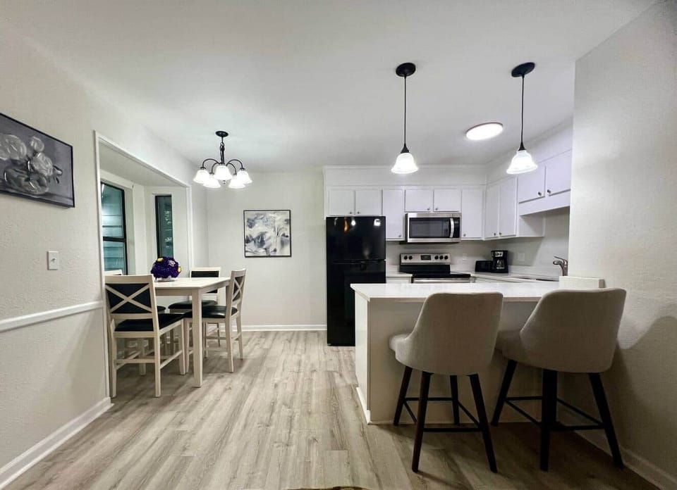 Gather for meals in the bright dining area, featuring a farmhouse-style table, modern lighting, and a window view. Perfect for family dinners, game nights, or morning coffee before exploring Clemson and the lakes.
