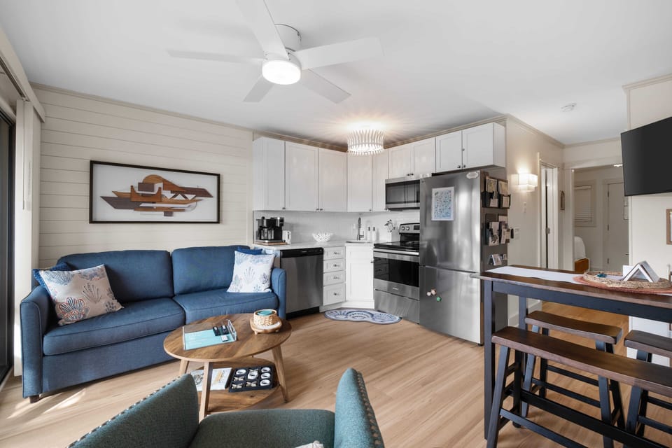Coastal charm meets modern comfort in this bright, beachy living room + kitchen