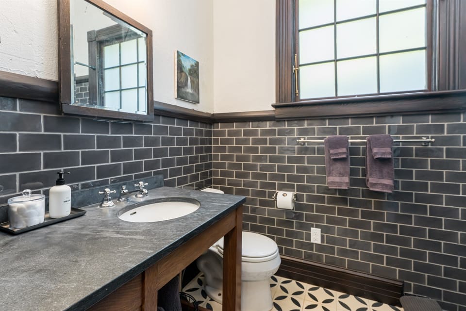 Full bathroom with a hallway/doors connecting it to both the first floor bedroom and the first floor common areas. The hallway door can be kept closed if you would like the bathroom to only be used by those staying in the first floor bedroom.