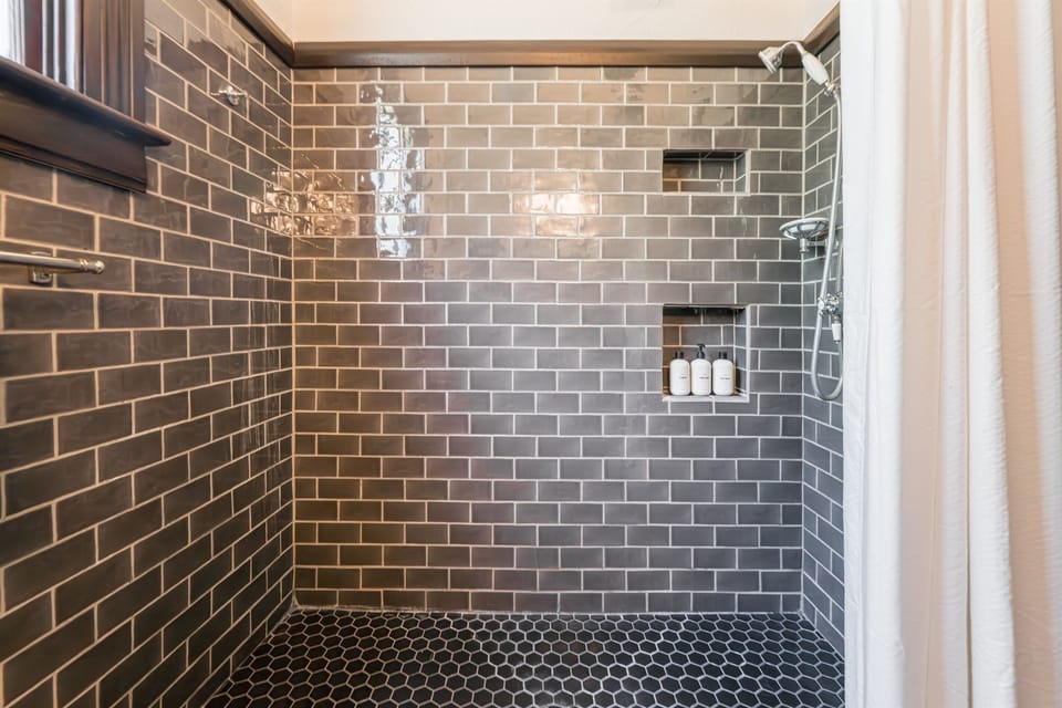 The shower has a low threshold. Access to room 1 is step free and we have a shower stool and a toilet seat riser with padded arms for extra support that we would be happy to set up upon request.