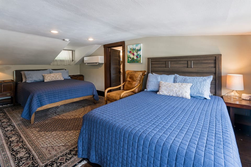 The third floor bedroom with two queen beds and an en suite bathroom. Note the lower ceiling height, I recommend another room for taller guests!