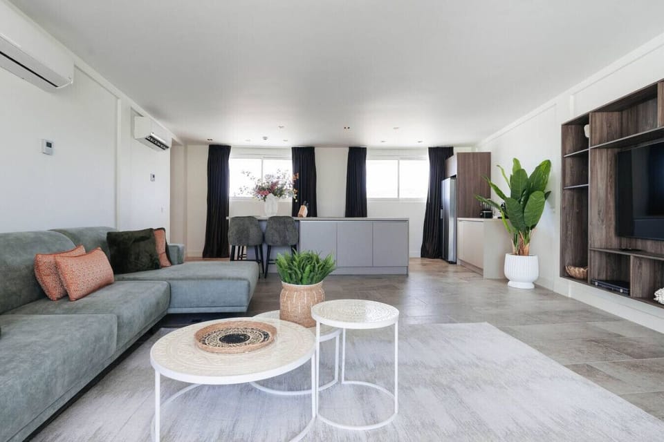 This living space is all about comfort and style! Imagine curling up on that cozy sofa after a day of exploring.