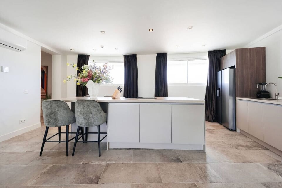 Check out this gorgeous kitchen! It’s bright and modern, with plenty of space to whip up your favorite meals.