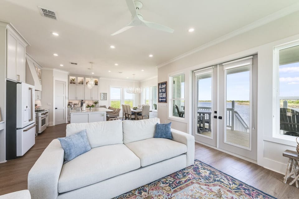 “Spacious and stylish – gather in this open-plan living and dining space with waterfront vibes.”