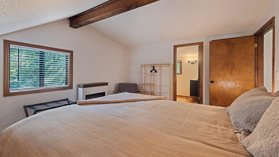 Inviting upstairs bedroom with sloped ceiling & peaceful comfort