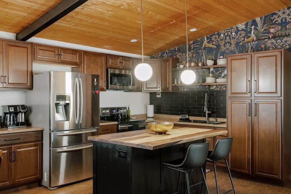 Fully stocked kitchen with coffee bar and island with seating.