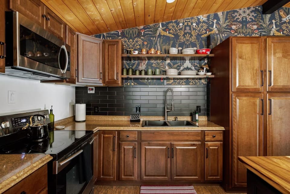 Fully stocked kitchen has oven, dishwasher, microwave and full-sized fridge.