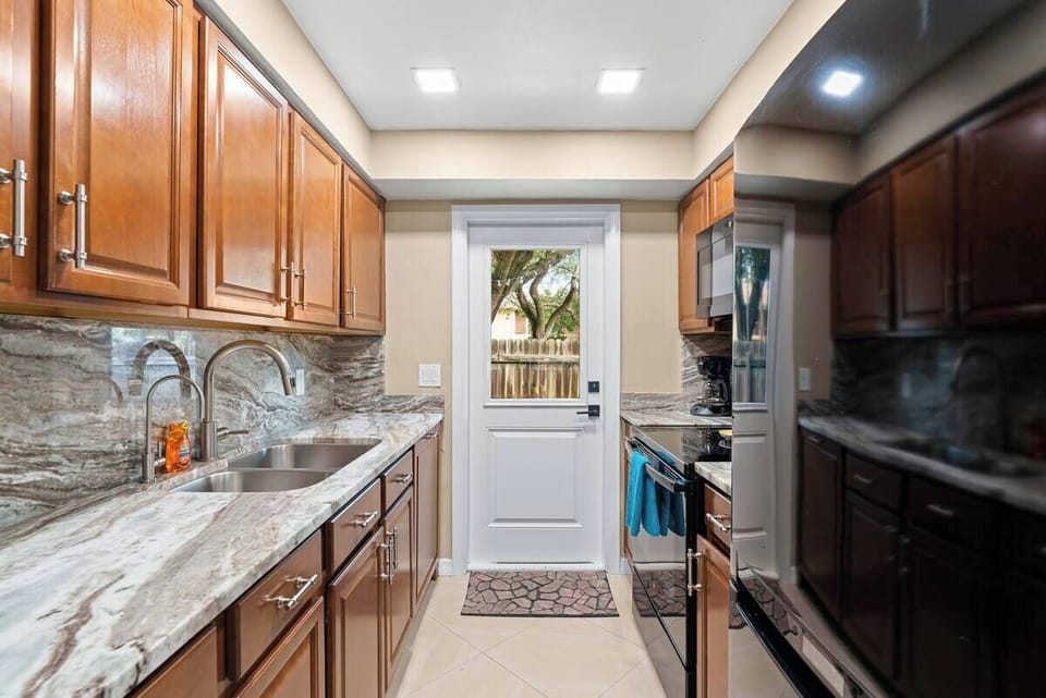 Galley style kitchen with backyard access 