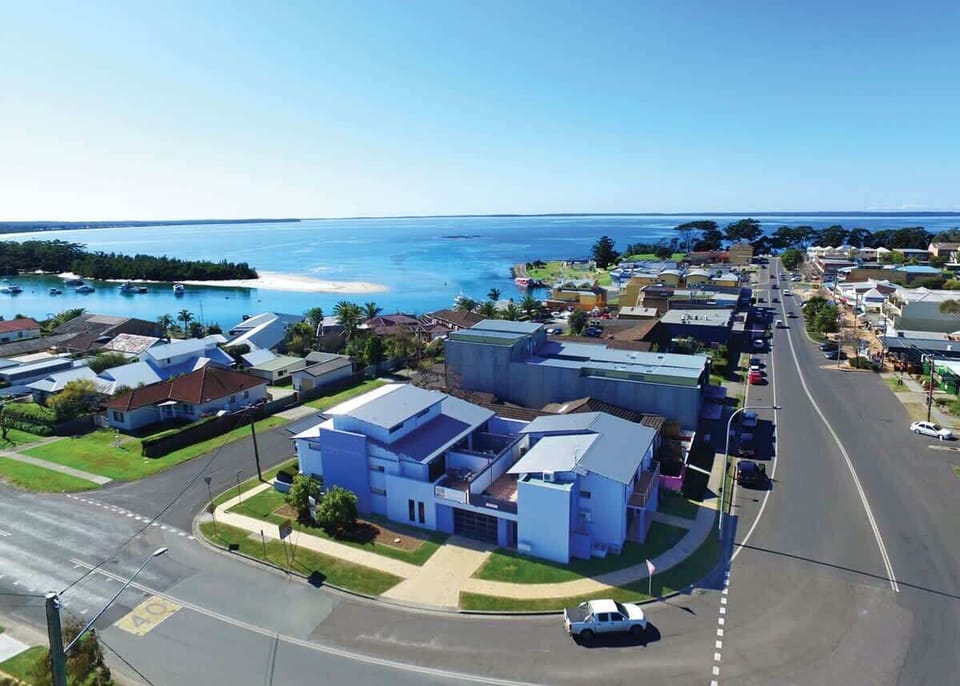 Aerial view of Nautilus Apartments accommodation in Huskisson and the main street of Huskisson 