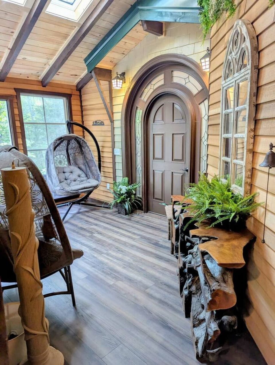 One-of-a-kind indoor porch retreat, filled with natural light that bring the feeling of the outdoors inside. This space is your grand entry to the Treehouse Master Suite, with a half bath and exterior entrance as well as interior access from the loft