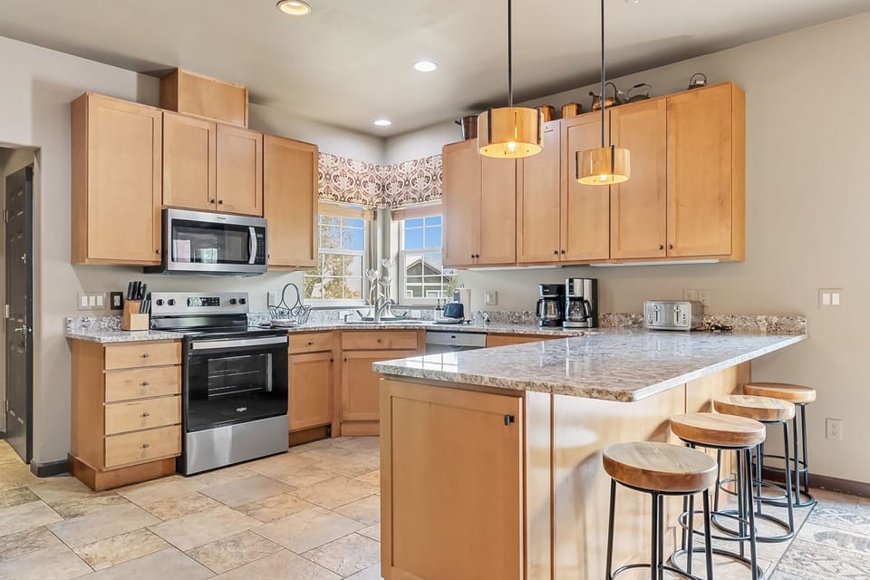 Kitchen: Main floor, drip coffee maker, French press, toaster, cooking utensils, tableware