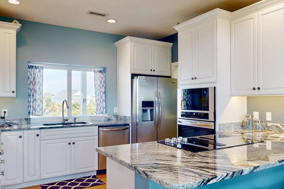 The kitchen features stainless steel appliances and everything you need to make a great meal