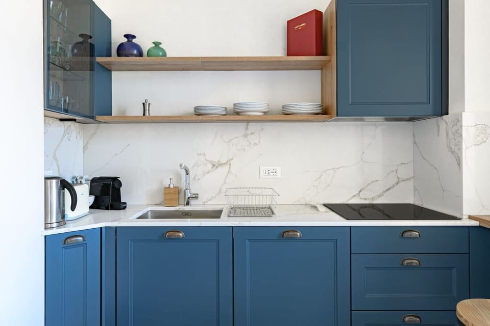 The compact and modern kitchen is equipped with all the essentials for your culinary needs.