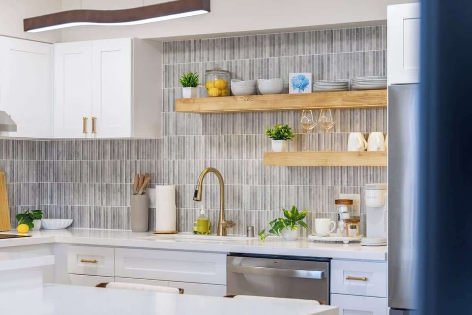 Wash up with ease in the modern kitchen, which includes a convenient dishwasher and is fully stocked with plates, bowls, glasses, and mugs.