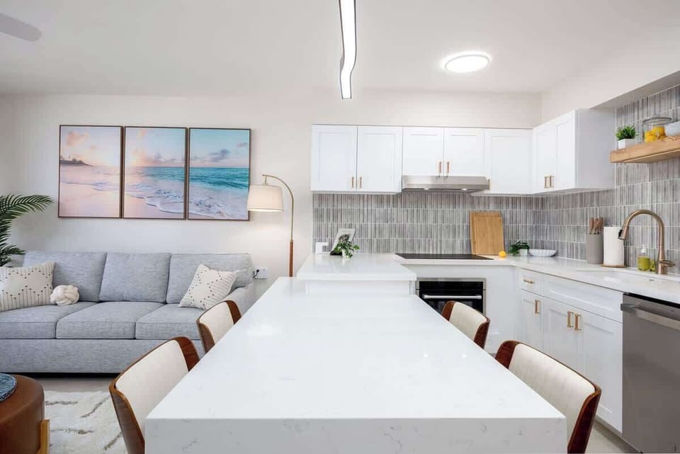 Gather with friends and family around the quartz breakfast bar in this open-concept living area, which features a sleek kitchen and a cozy living space with a pull-out sleeper sofa.
