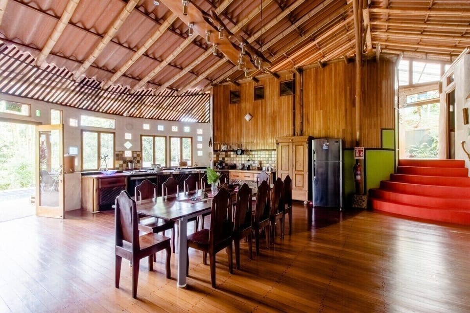 The huge diningtable and in the back the fully equiped kitchen.