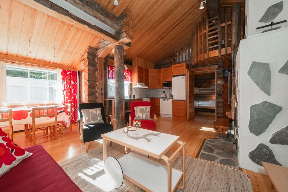 Relax in the comfy seating area by the fireplace, ideal for unwinding after a day exploring Ruka’s outdoors.