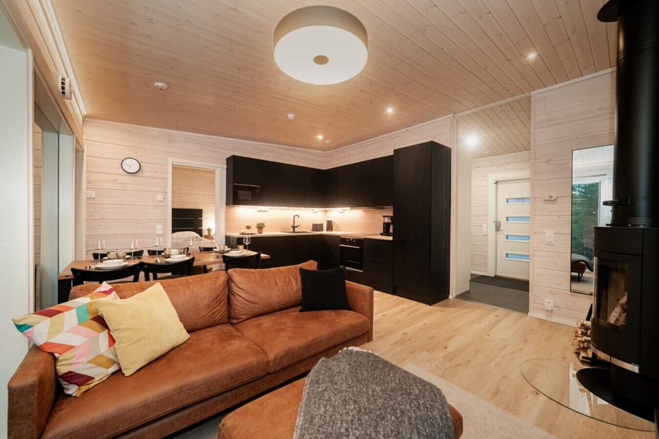 Spacious open-concept layout connecting the modern kitchen, dining area, and cozy lounge.