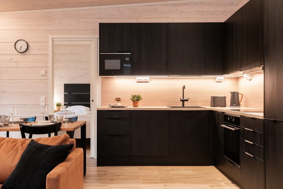 Sleek, modern kitchen with matte black cabinetry and high-quality appliances