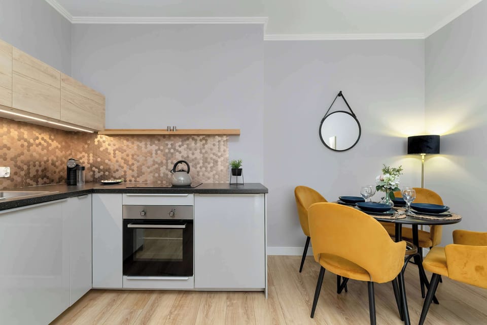 The sleek design of the kitchenette blending seamlessly with the living area.