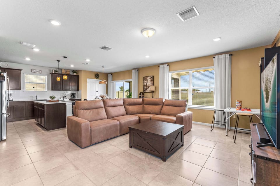 Bright living area with reclining sofa equipped with USB charging ports, and Smart TV