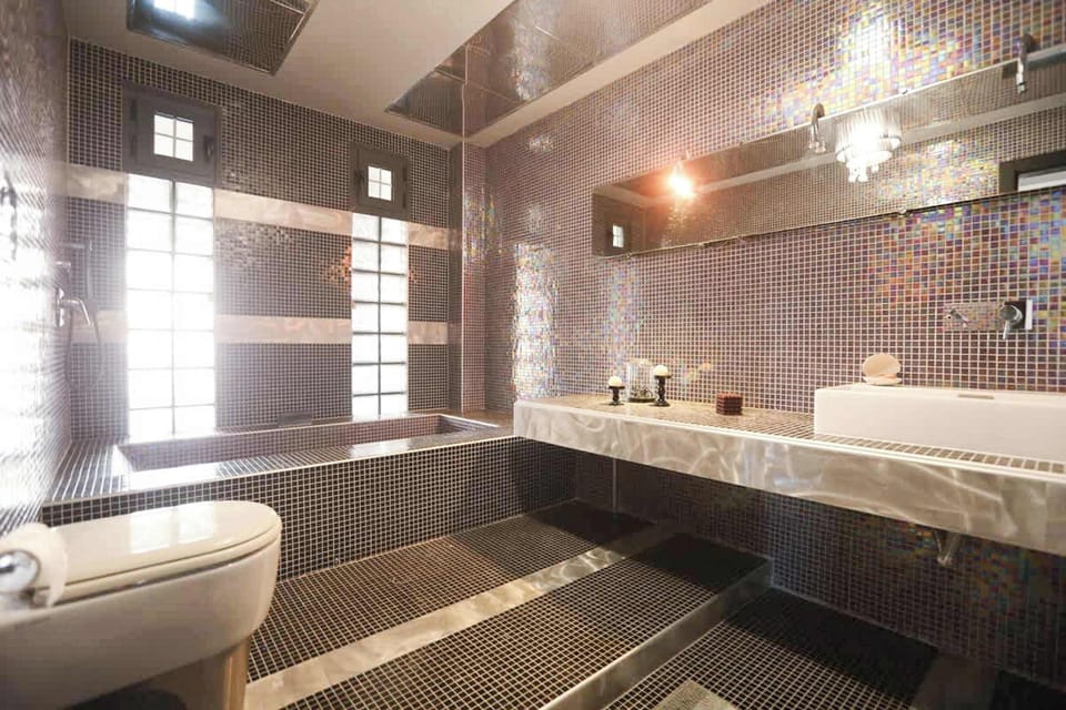 Bathroom 1: With Bathtub, Modern Fixtures, and Elegant Tiling for Relaxation