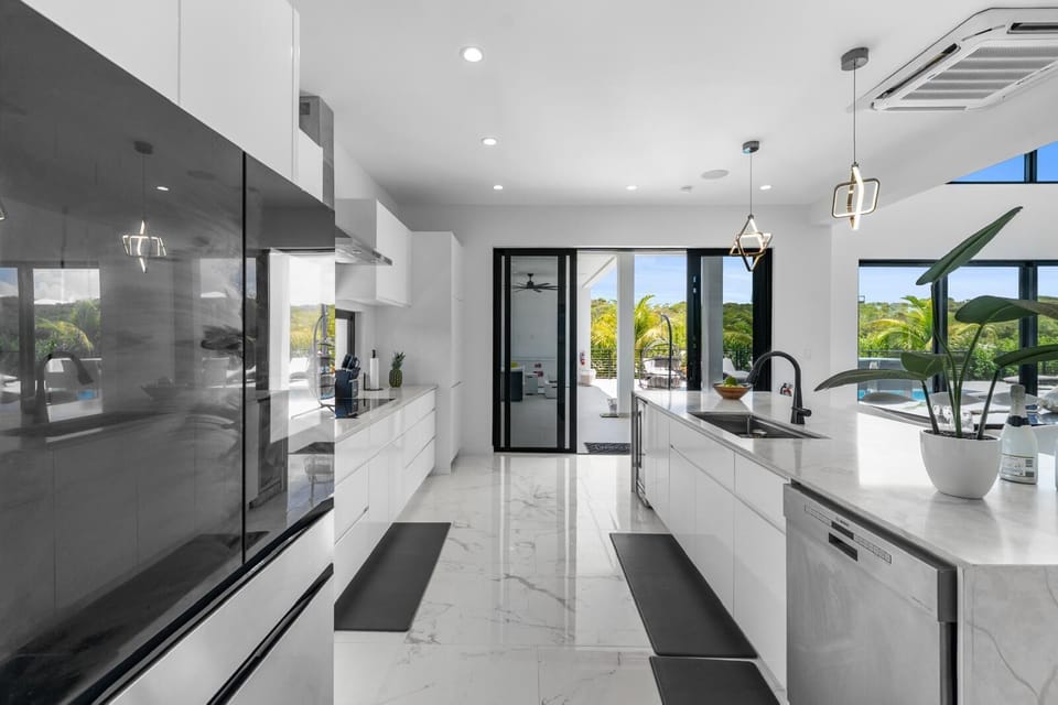 Sleek, fully-equipped kitchen with white cabinetry.