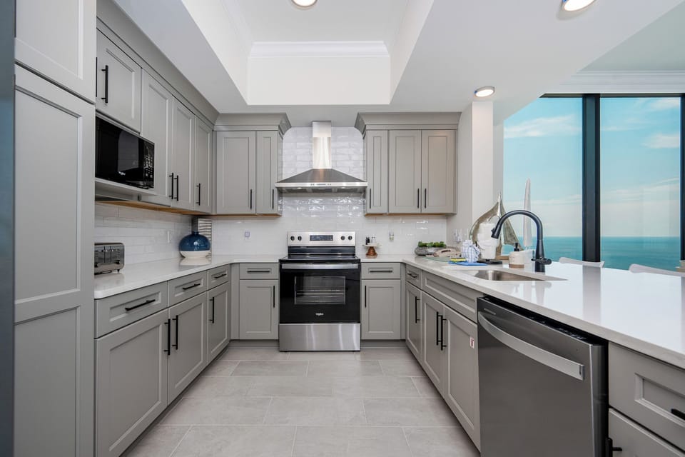 Prepare meals with a beachfront view through the large windows in this stylish kitchen space