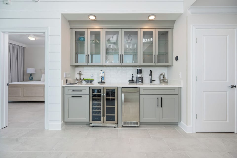 Enjoy preparing drinks and snacks at this stylish wet bar, complete with a wine cooler and elegant cabinet display