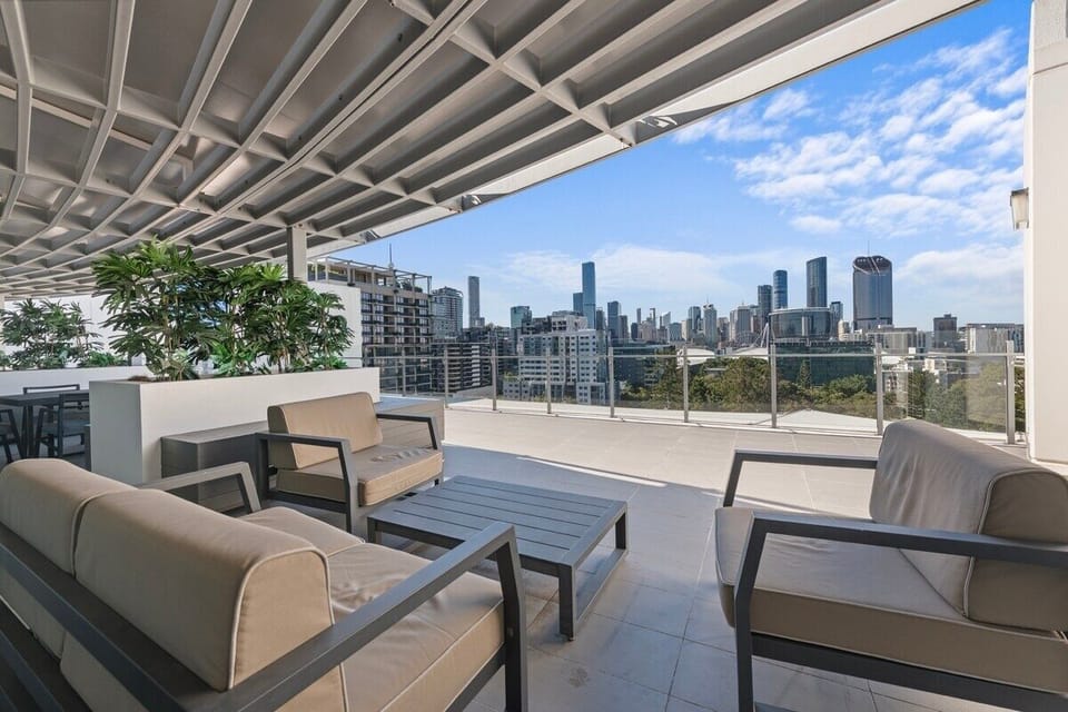 Secure entry, rooftop lounge, BBQ deck, and skyline outlook.