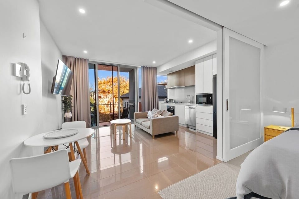 Lounge with sofa bed, 55-inch 4K Smart TV, ducted AC, and extra sleep space.