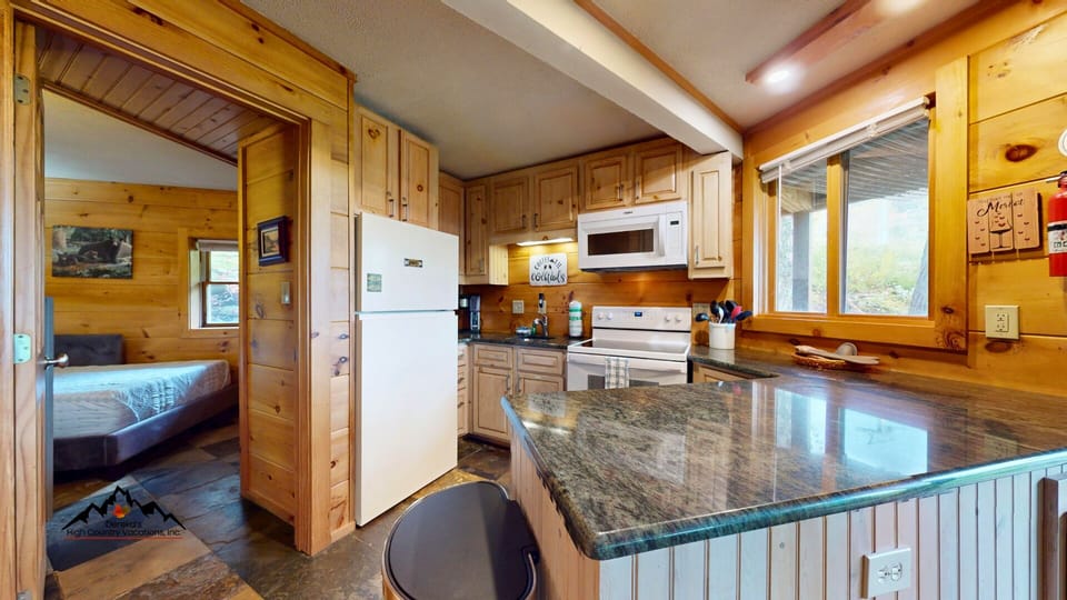 The fully equipped kitchen includes everything needed for meals after a day of skiing or mountain adventures.