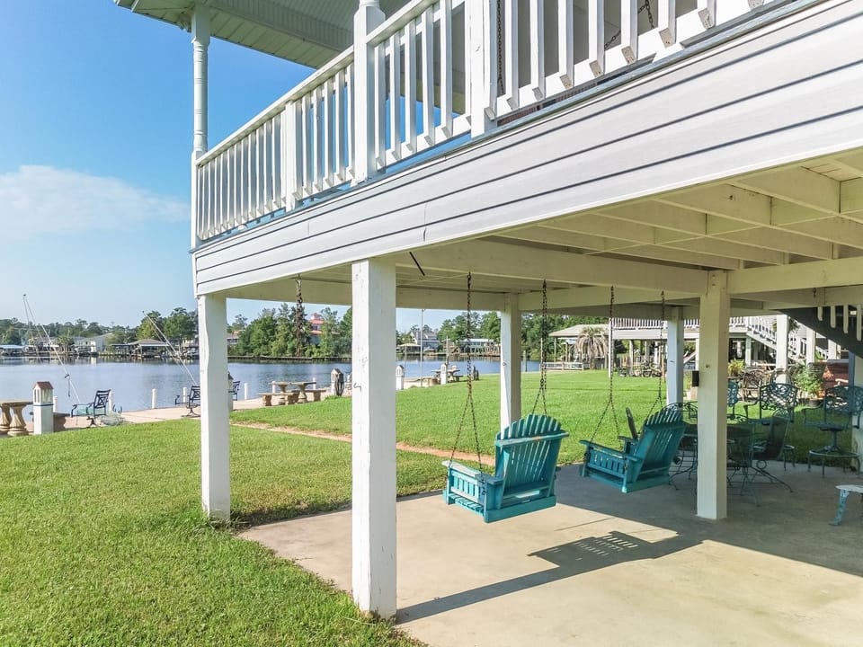Enjoy beautiful views of the river from the comfortable swings located beneath the house, inviting moments of tranquility.