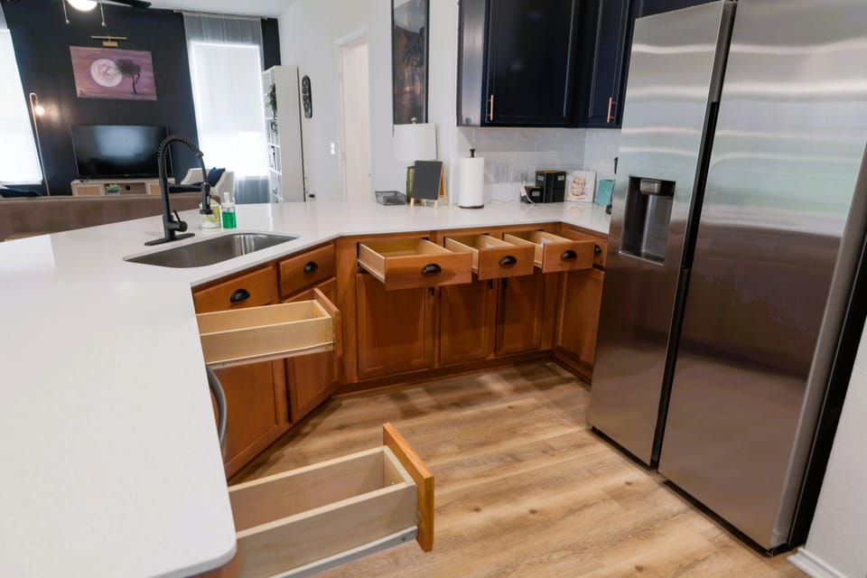 Modern fridge and open counter space for your convenience while preparing meals.